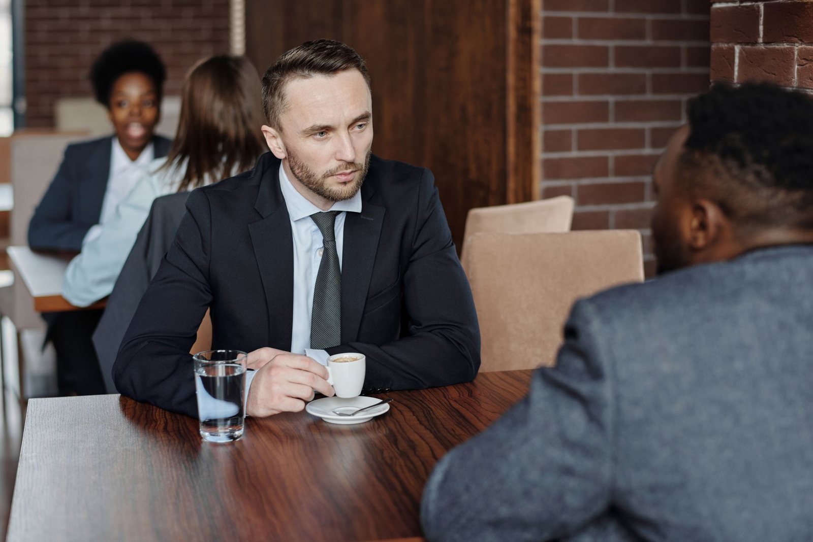 Dos personas conversando con un café, reflejo de las relaciones en la carta natal