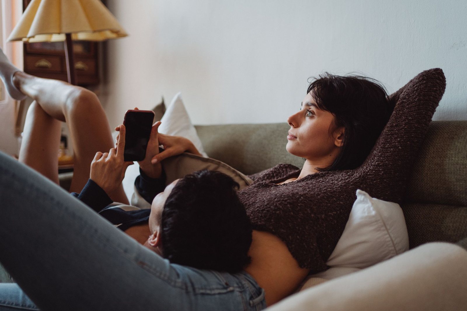Pareja descansando en el sofá, convivencia tranquila según su compatibilidad luna