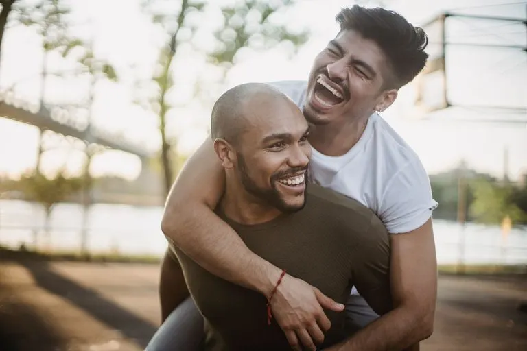 Pareja apasionada riendo al aire libre, imagen del alma gemela de Aries
